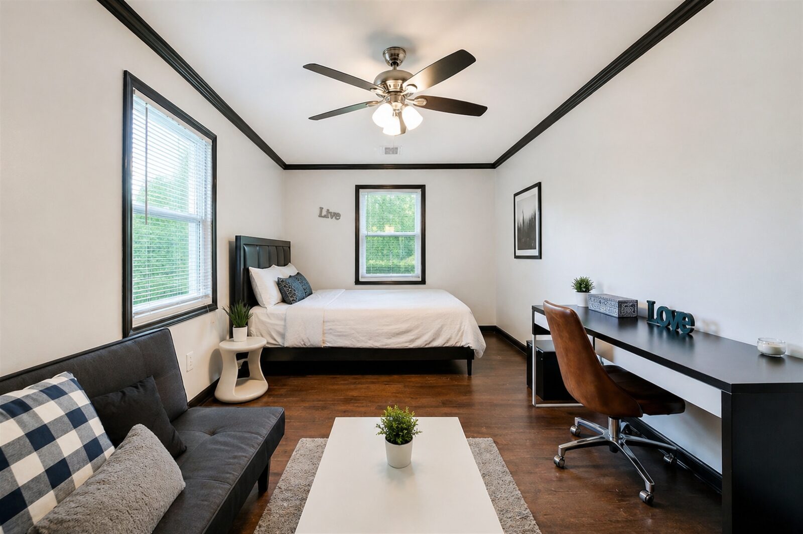 The private bedroom at 854 Bonneville — furnished with bed, desk, seating area, hardwood floors and natural daylight